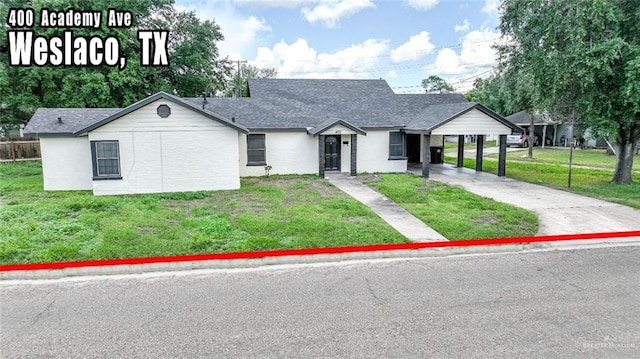 single story home with a front lawn and a carport