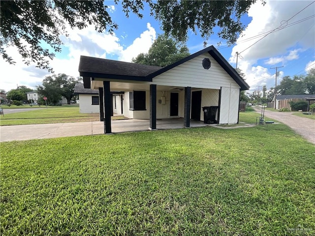 view of front facade with a carport and a front lawn