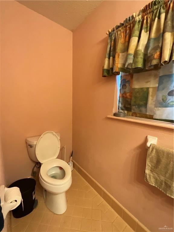 bathroom with tile patterned floors and toilet