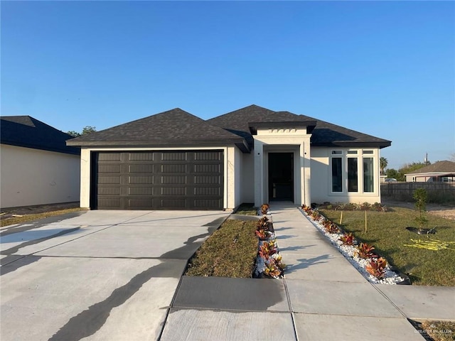 view of front of property featuring a garage and a front yard