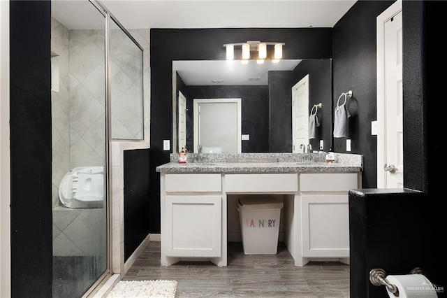 14205 Sweet Water Way, Mcallen, TX 78504 - bathroom with a shower stall, vanity, and wood finished floors