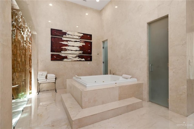 bathroom with a bathtub and tile walls