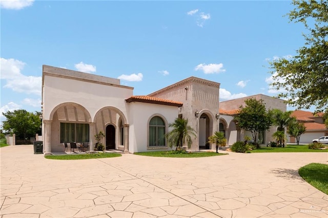 mediterranean / spanish house featuring a patio area