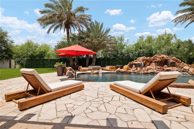 view of pool featuring pool water feature and a patio area