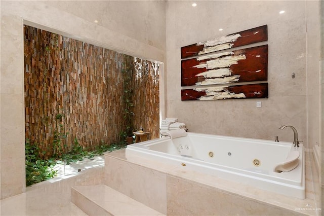 bathroom featuring tile walls and tiled tub