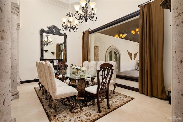 dining area featuring ornate columns, crown molding, and an inviting chandelier