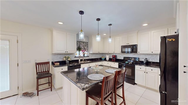 kitchen featuring light tile patterned floors, black appliances, tasteful backsplash, and white cabinets