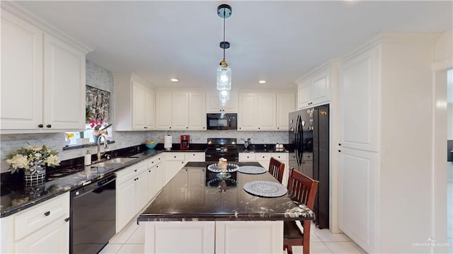 kitchen featuring black appliances, a sink, and white cabinetry