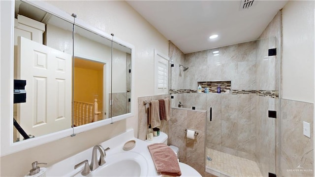 full bath with visible vents, toilet, a shower stall, a sink, and recessed lighting