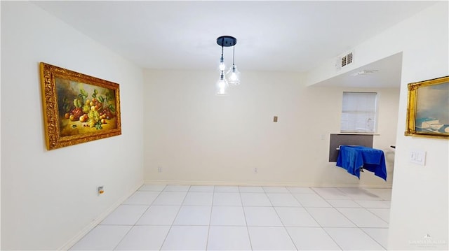 spare room with visible vents, baseboards, and tile patterned floors