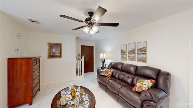 living room with a ceiling fan, visible vents, and light tile patterned floors