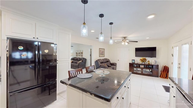 kitchen with decorative light fixtures, recessed lighting, freestanding refrigerator, open floor plan, and white cabinets