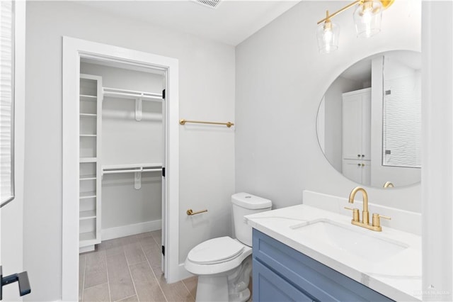 3925 S Mullin Ave, Edinburg, TX 78542 - bathroom with vanity, a spacious closet, and wood tiled floors
