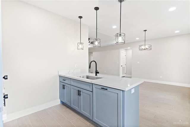 3925 S Mullin Ave, Edinburg, TX 78542 - kitchen with recessed lighting, a peninsula, light countertops, hanging light fixtures, and light wood finished floors