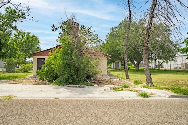 exterior space with a front lawn and an outdoor structure