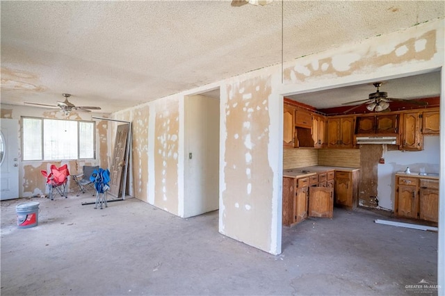 kitchen with a textured ceiling, tasteful backsplash, and ceiling fan