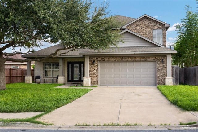 3716 Yellowhammer Ave, Mcallen, TX 78504 - view of front of house featuring concrete driveway, brick siding, an attached garage, and a shingled roof