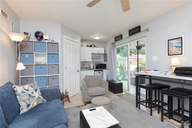 living room featuring ceiling fan and bar