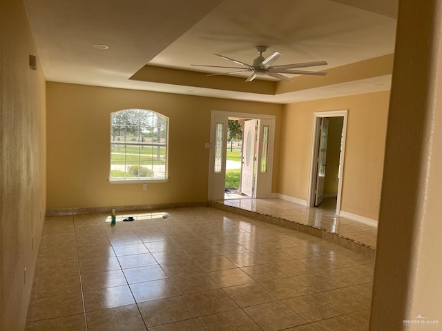 tiled empty room with ceiling fan