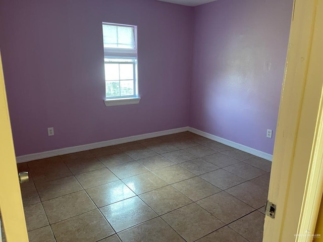 unfurnished room featuring light tile patterned floors