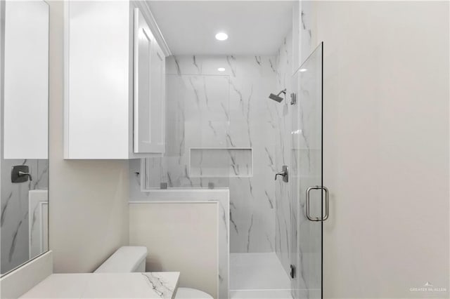 bathroom with vanity, an enclosed shower, and toilet