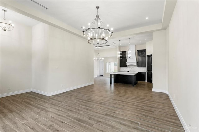 kitchen featuring hardwood / wood-style floors, a kitchen island, and hanging light fixtures