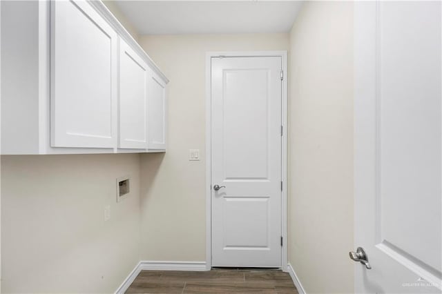 laundry area with cabinets, washer hookup, and dark hardwood / wood-style floors