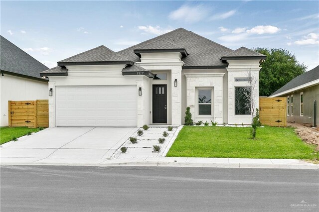 view of front of home with a garage and a front lawn