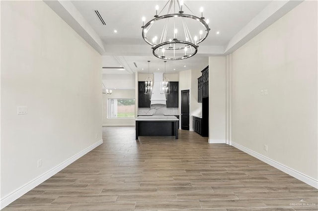 interior space with wood-type flooring and an inviting chandelier