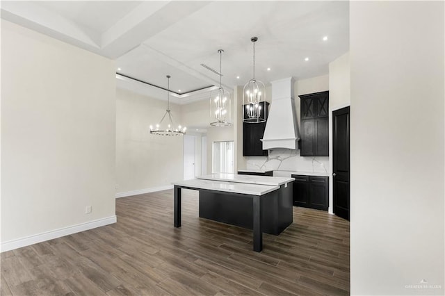 kitchen featuring premium range hood, a breakfast bar, pendant lighting, dark hardwood / wood-style floors, and a kitchen island