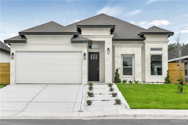 prairie-style house with a garage and a front yard