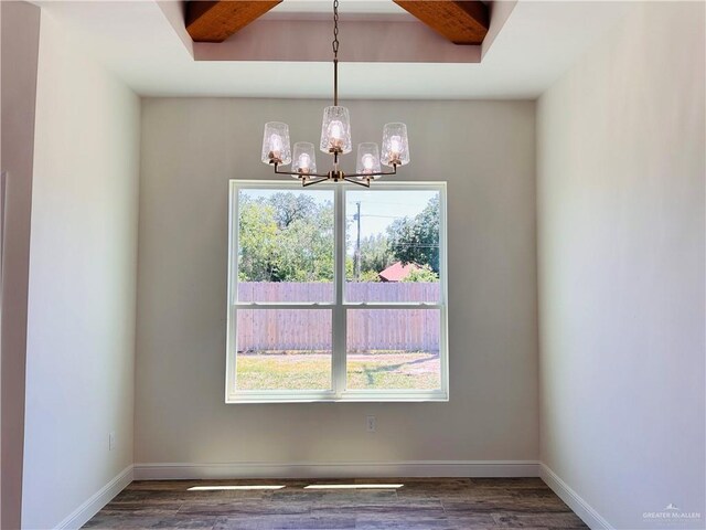 2201 Blue Sky Dr, Weslaco, TX 78599 - spare room featuring a chandelier, healthy amount of natural light, and wood finished floors