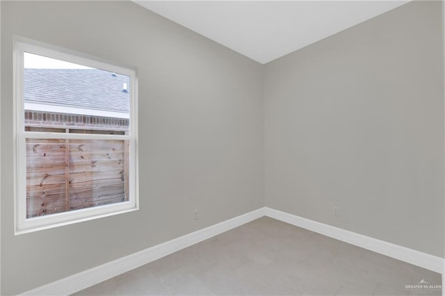 spare room with baseboards