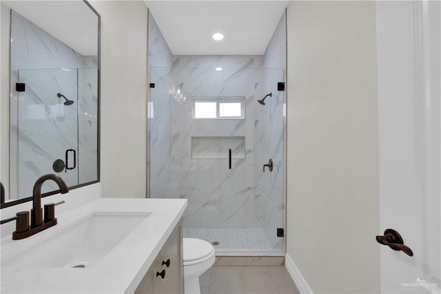 full bathroom featuring a marble finish shower, baseboards, toilet, tile patterned flooring, and vanity