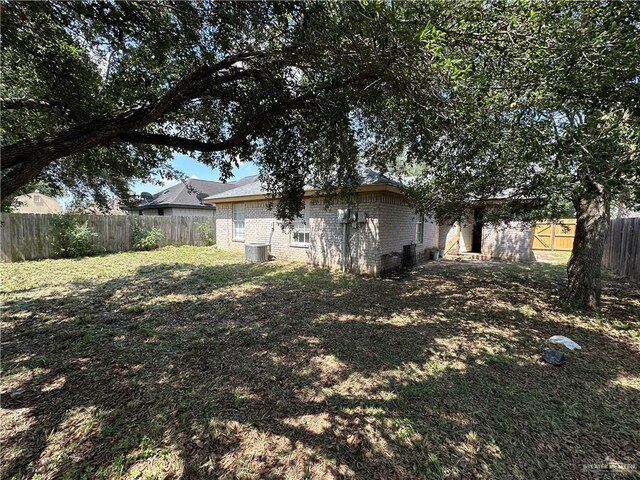 8802 N 29th Ln, Mcallen, TX 78504 - rear view of house featuring brick siding and a fenced backyard