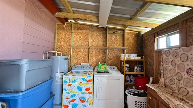 laundry room with wood walls, washer / dryer, and water heater