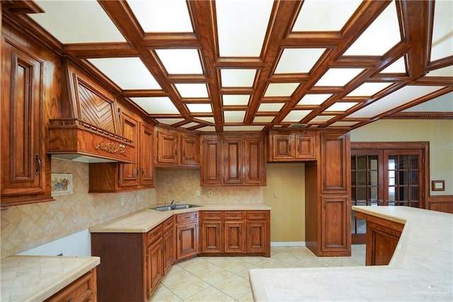 kitchen with tasteful backsplash, sink, light tile patterned floors, and french doors