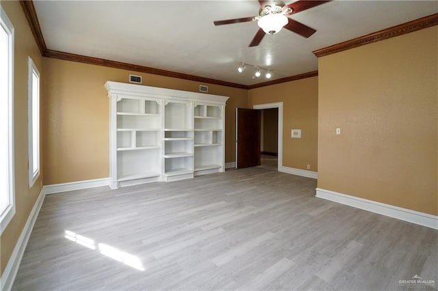 interior space featuring multiple windows, ornamental molding, ceiling fan, and light hardwood / wood-style flooring