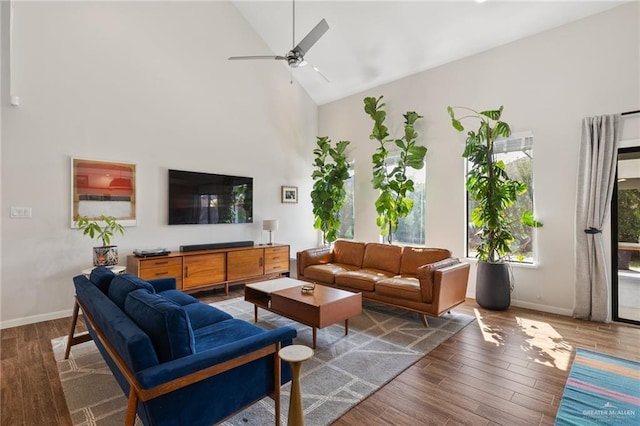 living room with ceiling fan, dark hardwood / wood-style floors, and high vaulted ceiling