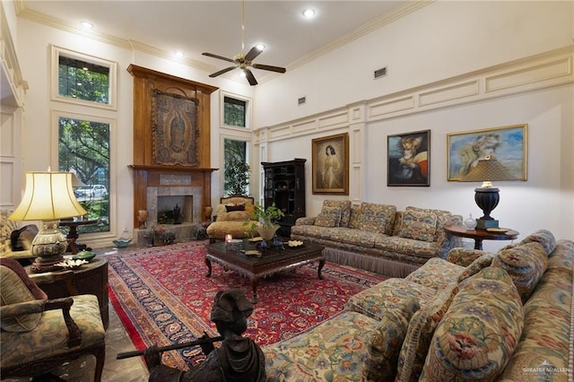 408 E Newport Ln, Mcallen, TX 78501 - living area featuring a decorative wall, ornamental molding, ceiling fan, a high ceiling, and a fireplace