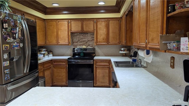 2104 Harvey St, Mcallen, TX 78501 - kitchen with electric range, brown cabinets, a sink, light countertops, and stainless steel fridge