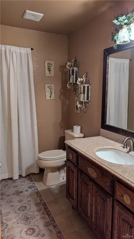 2104 Harvey St, Mcallen, TX 78501 - bathroom featuring toilet, visible vents, tile patterned flooring, and vanity