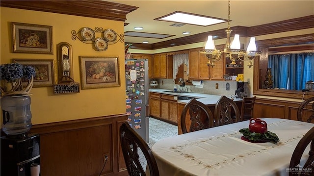 2104 Harvey St, Mcallen, TX 78501 - kitchen with an inviting chandelier, ornamental molding, wainscoting, and brown cabinets