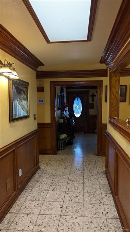 2104 Harvey St, Mcallen, TX 78501 - hallway with crown molding, wainscoting, a decorative wall, and a skylight