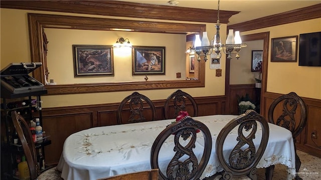 2104 Harvey St, Mcallen, TX 78501 - dining space featuring an inviting chandelier, ornamental molding, and wainscoting