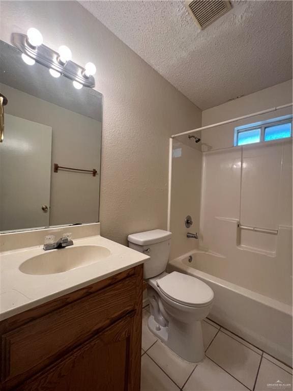 full bathroom featuring tile patterned floors, shower / bathing tub combination, a textured ceiling, toilet, and vanity