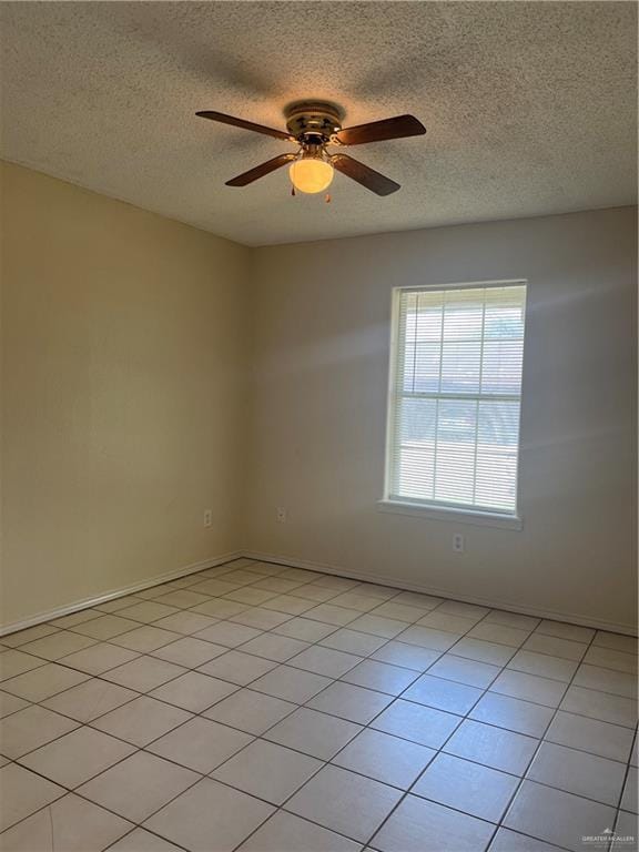 tiled spare room with ceiling fan and a textured ceiling