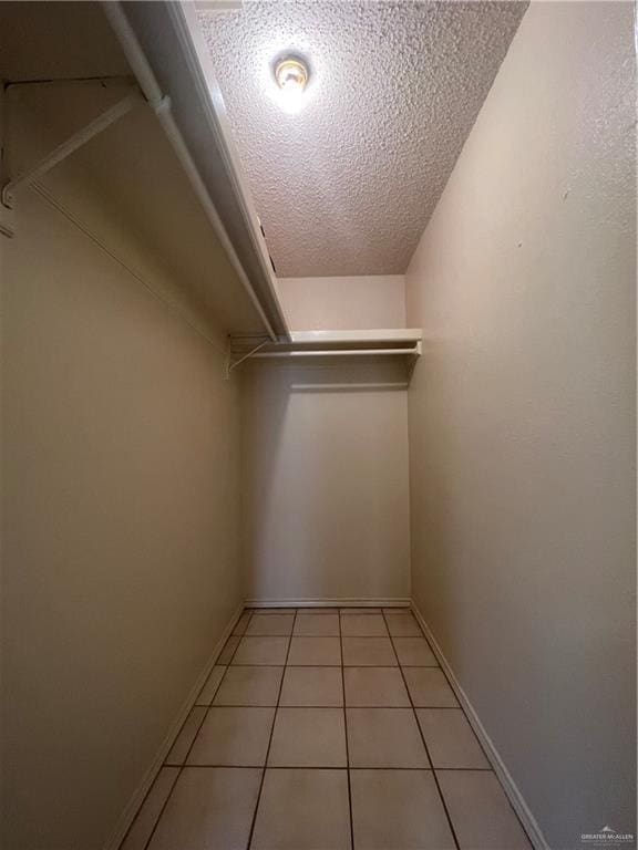 walk in closet featuring light tile patterned flooring