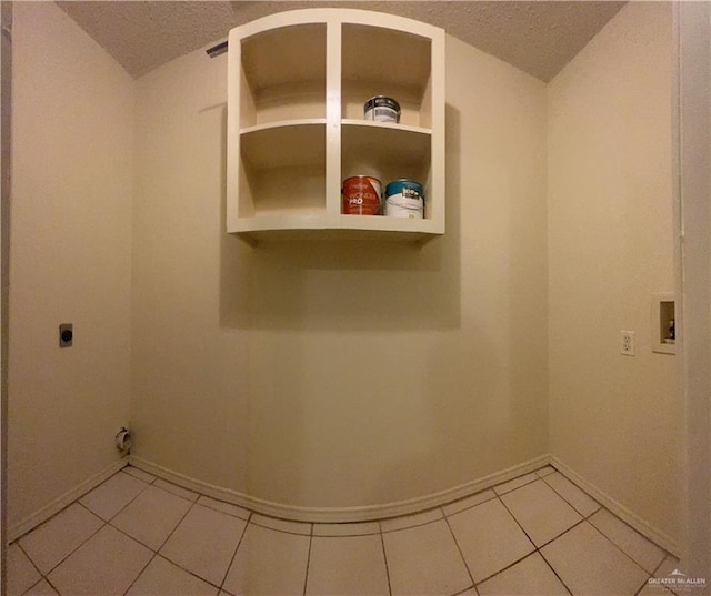 laundry room with hookup for an electric dryer, hookup for a washing machine, and light tile patterned flooring