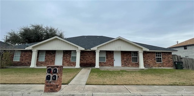 single story home featuring a front lawn and a porch